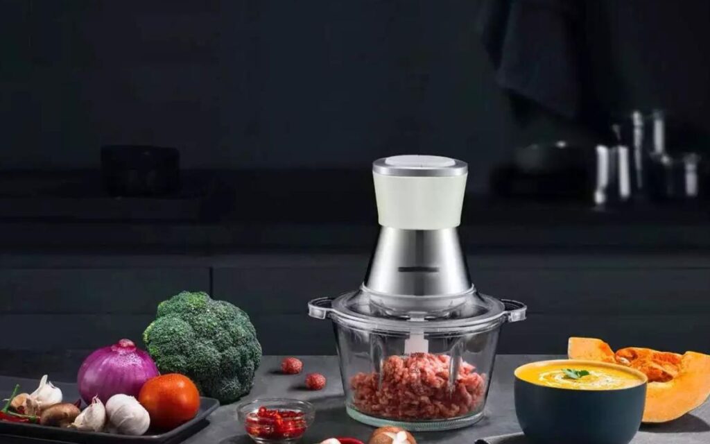 How does the capacity of the food processor affect meat grinding?