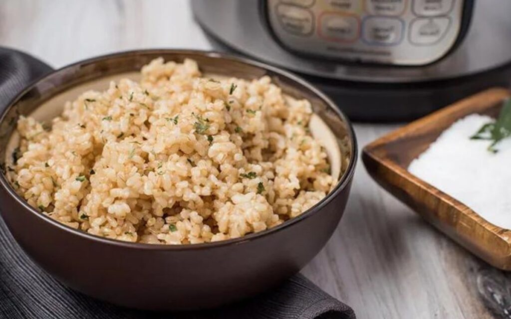 Why does brown rice need more water to cook in a rice cooker?